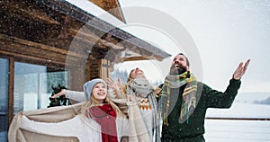 Family with small daughter having fun on terrace outdoors, holiday in winter nature.