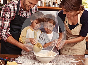 Family, smile and kids baking in kitchen, learning or happy boys bonding together with parents in home. Father, mother