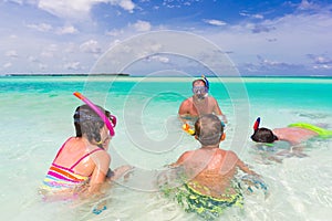 Family snorkeling in sea