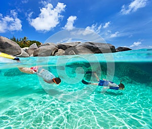 Family snorkeling in tropical water