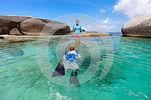 Family snorkeling in tropical water