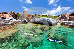 Family snorkeling at tropical water