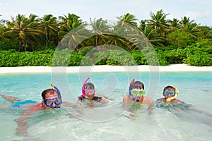 Family snorkeling in water