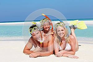 Family With Snorkels Enjoying Beach Holiday