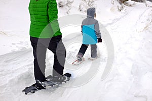 Family Snowshoeing in the Winter Snow kids having fun