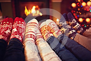 Family in socks near fireplace in winter photo