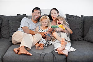 Family on Sofa Playing Video games