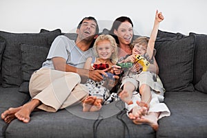 Family on Sofa Playing Video games