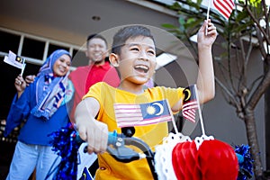 Family and son celebrating malaysia merdeka or malaysian independence day