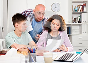 Family with son working with papers