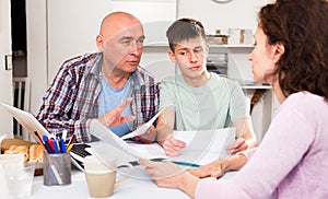 Family with son working with papers