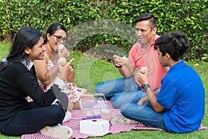 Family spending a day outdoors, having a picnic