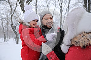 Family spending time outside on winter day. Christmas vacation