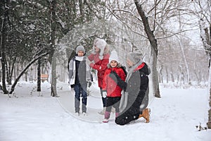 Family spending time outside on winter day. Christmas vacation