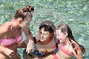 Family spending time together in a crystalclear water of river