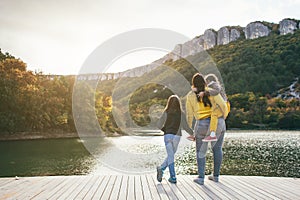 Family spending time together by the lake