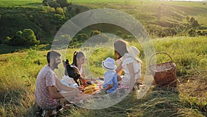 Family spending time together on a picnic with their dog