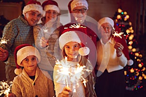 family spending time together with sparklers celebrating Christmas .