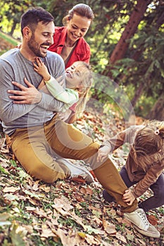 Family spending time together, tickling father is fun.
