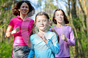 Family sport, happy active mother and kids jogging outdoors