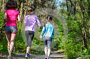 Family sport, happy active mother and kids jogging outdoors