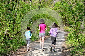 Family sport, happy active mother and kids jogging outdoors