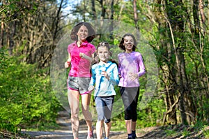 Family sport, happy active mother and kids jogging outdoors