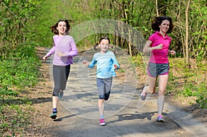 Family sport, happy active mother and kids running in forest
