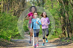 Family sport, happy active mother and kids running in forest