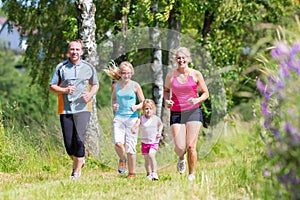 Family sport jogging through field