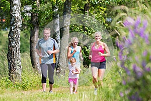 Family sport jogging through field