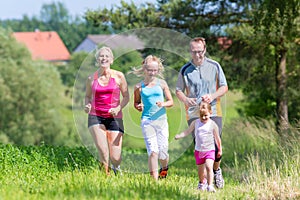 Family sport running through field