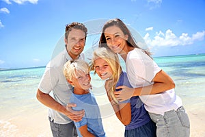 Family standing on a beautiful beach