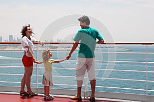 Family standing on cruise liner deck