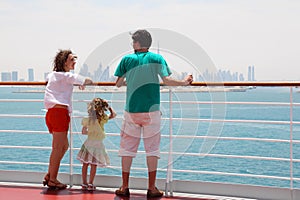 Family standing on cruise liner deck