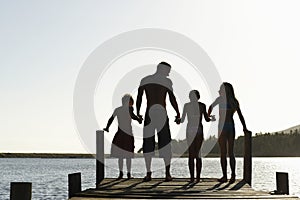 Family Standing On Edge Of Jetty