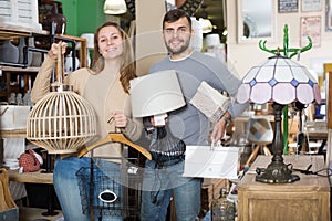 family standing with purchases in furnishings store