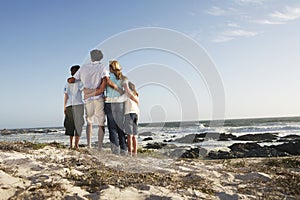 Family Standing Together On Seashore