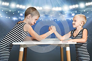 Family of strongman. Brothers in vintage costume of athletes compete in arm wrestling. Family look.