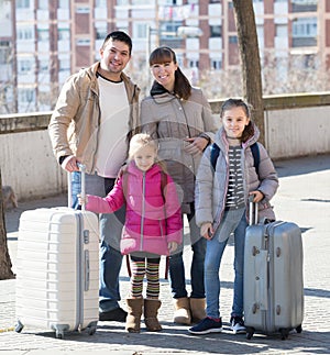 Family with suitcases in journey