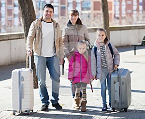 Family with suitcases in journey