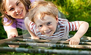 Family summer on ladder to tree house