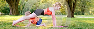 Family summer outdoor sport activity. Caucasian mother with child toddler boy doing workout yoga in park. Woman doing physical