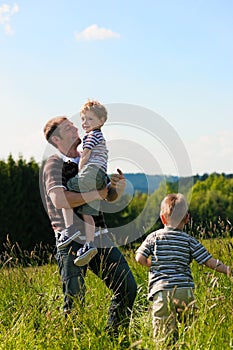 Family summer - playing on the meadow