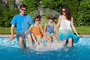 Family summer vacation near swimming pool