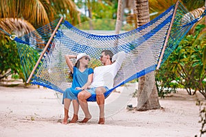 Family on summer vacation relaxing in hammock