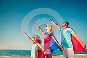 Family of superheroes on the beach. Summer vacation concept