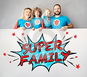 Family of superheroes holding banner