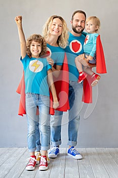 Family of superheroes playing at home