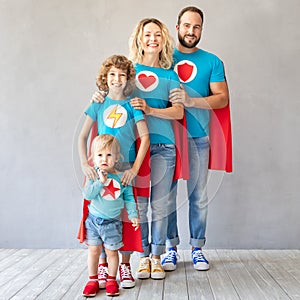 Family of superheroes playing at home